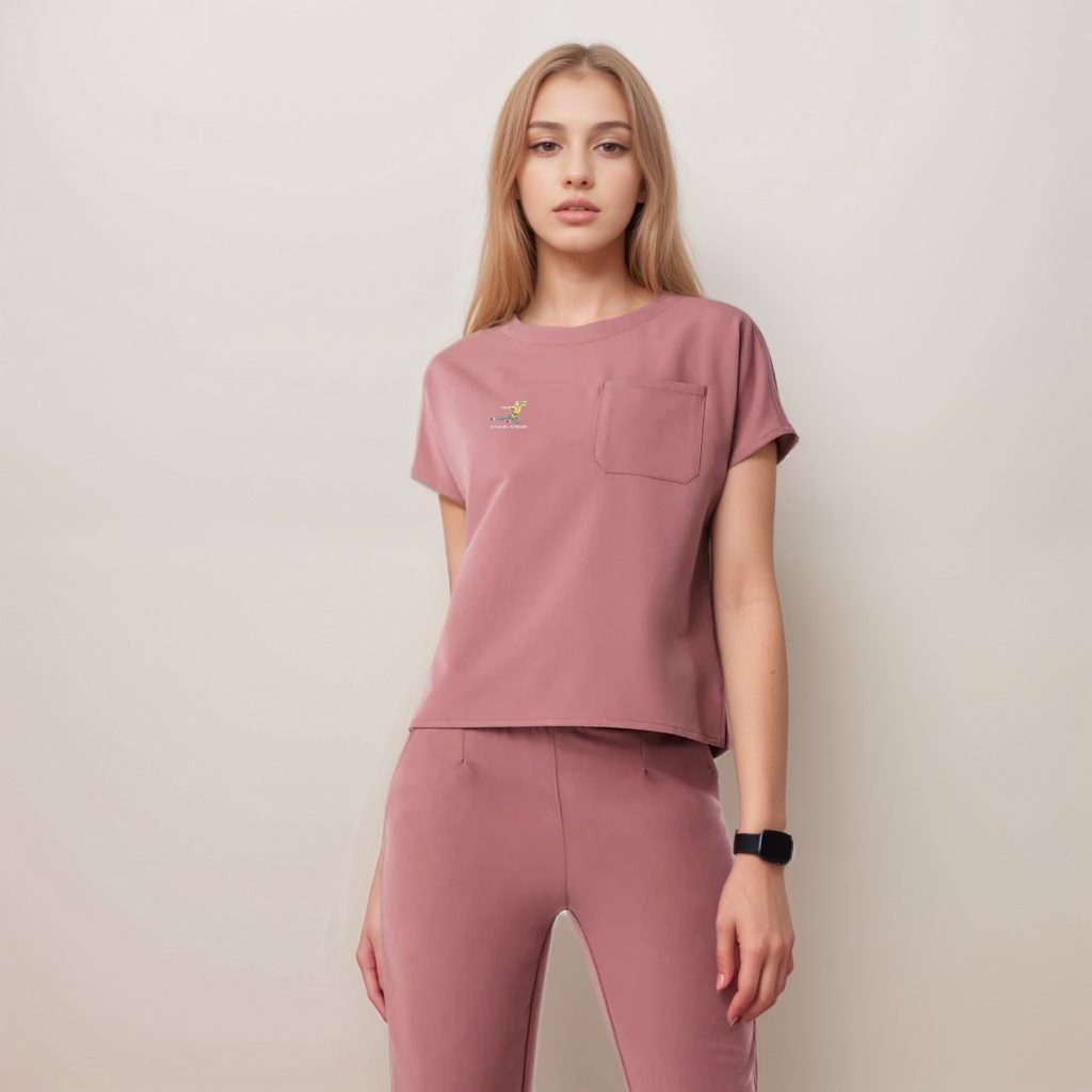 Side view of a pink women's medical scrub top showing chest pocket and short sleeves, designed for all-day comfort.