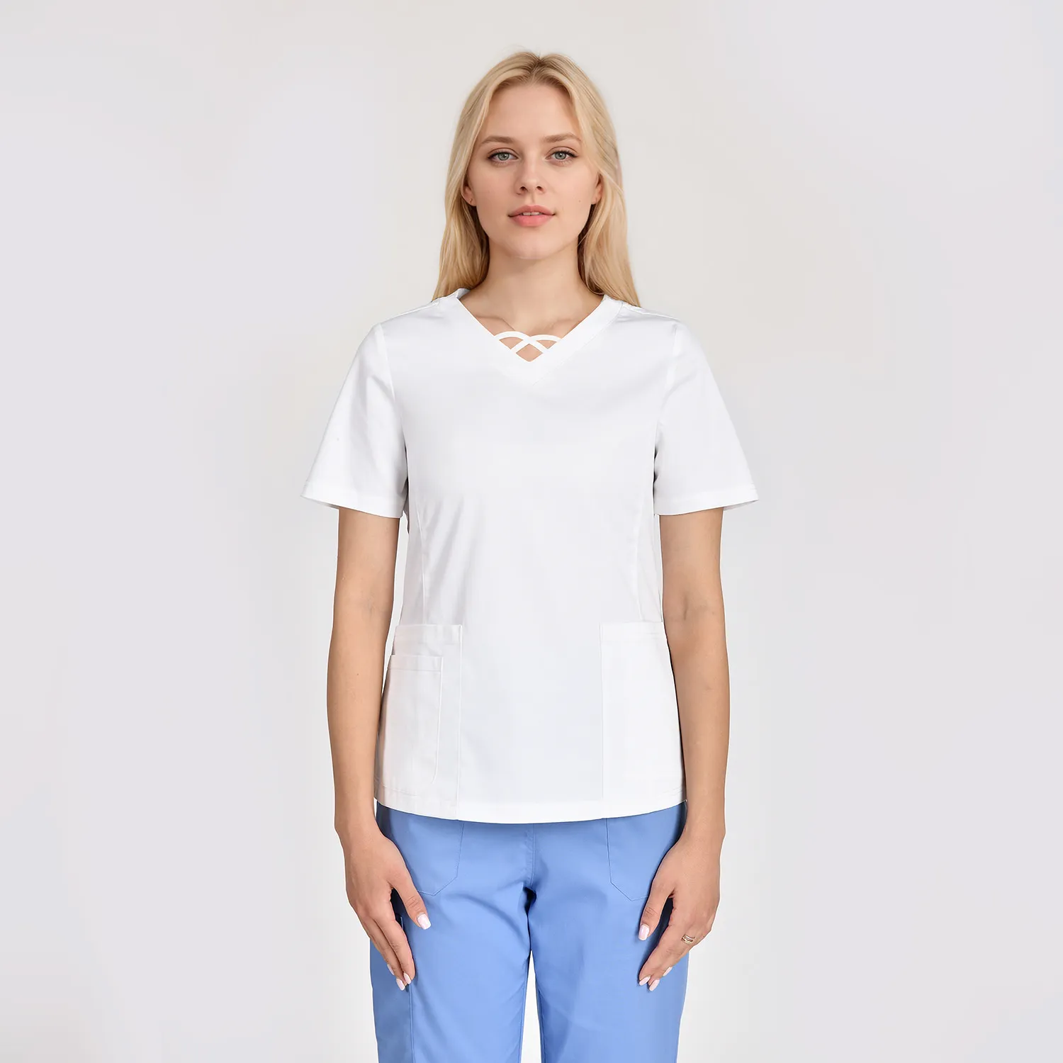 Women's white V-neck scrub top with short sleeves and two front pockets, designed for comfort and functionality in medical settings.