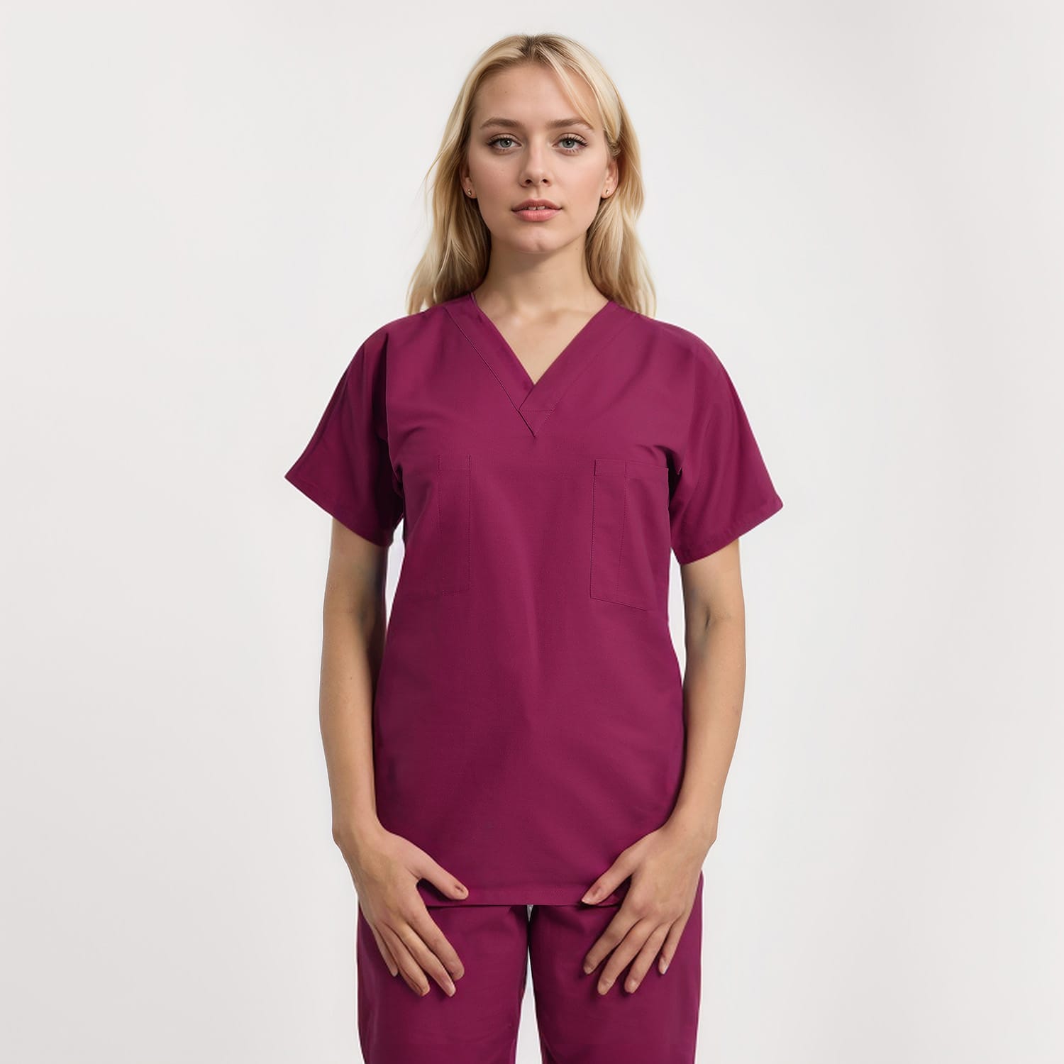 Front view of a model wearing a reversible V-neck scrub top in a unisex style with one pocket, perfect for healthcare professionals.