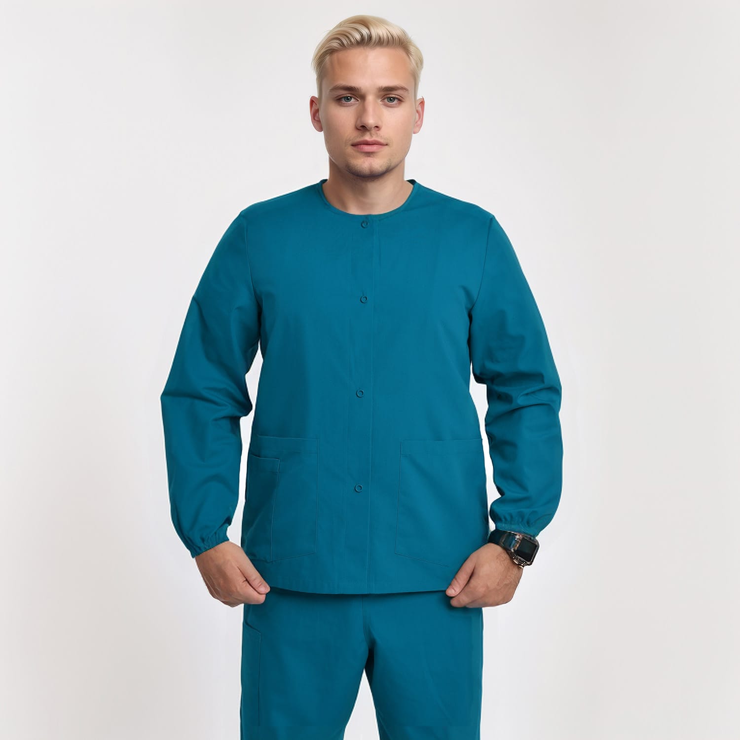 Front view of a model wearing a teal unisex 3-pocket warm-up scrub jacket with long sleeves, ideal for healthcare professionals.