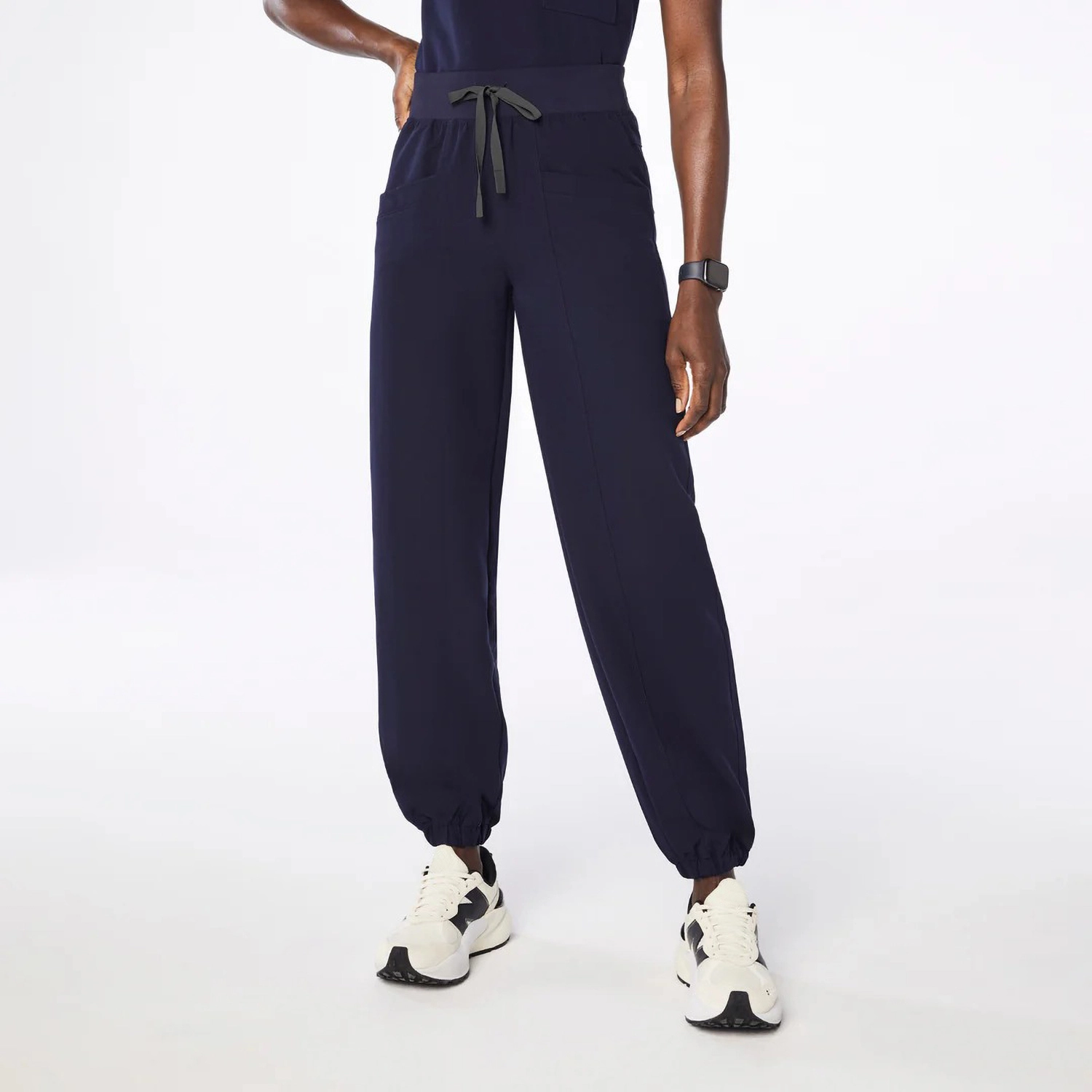 Women's navy blue medical scrub pants with a drawstring waist, tapered jogger-style legs, and side pockets, offering comfort and durability for healthcare professionals.